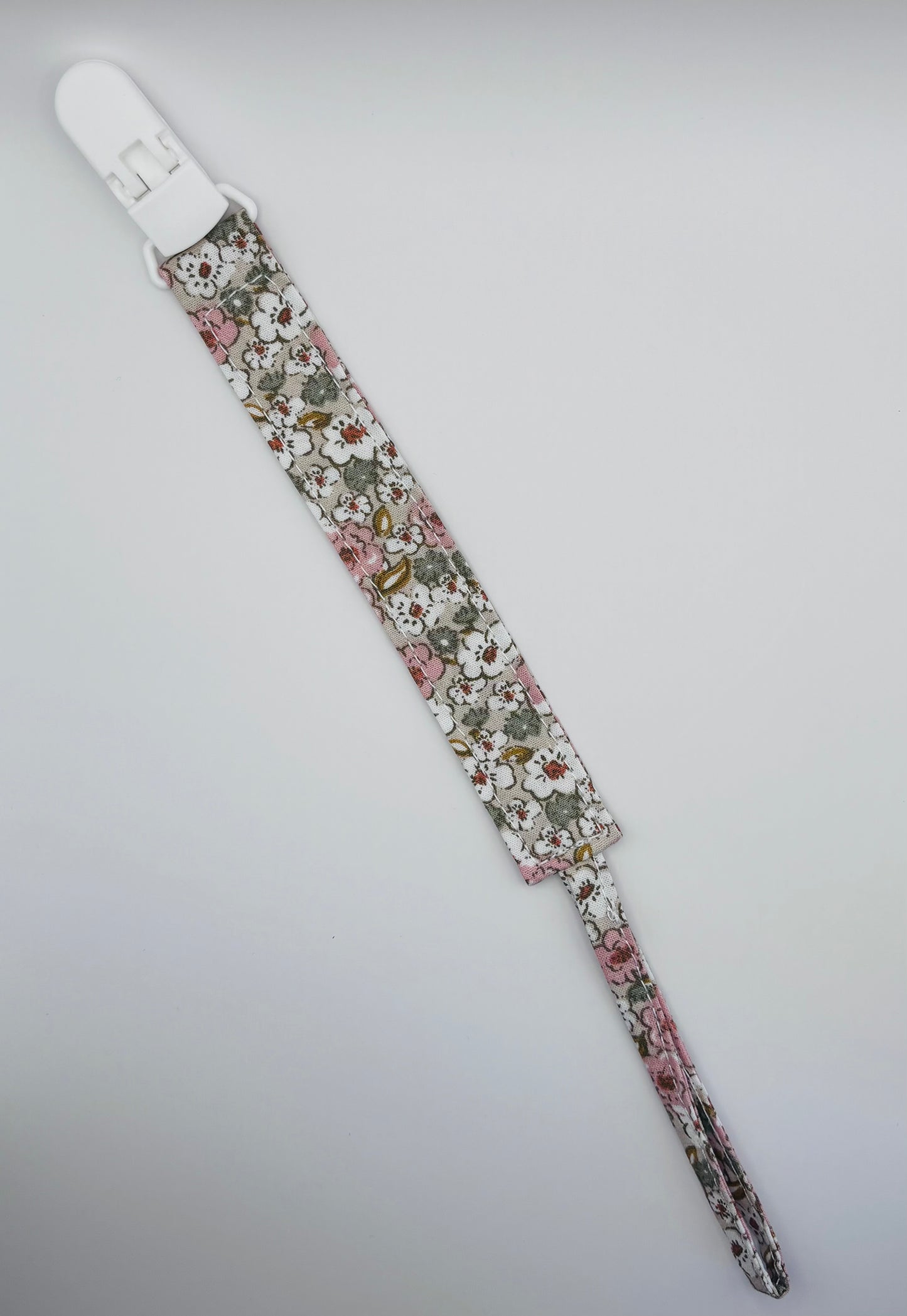 attache-tétine Bubuclip en tissu fleuri rose - petit beba